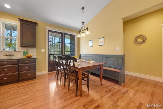 409 Pawnee Dr, Irondale, MO 63648 - dining area featuring light wood-style floors, lofted ceiling, and baseboards