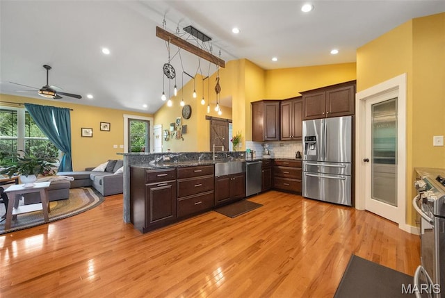 409 Pawnee Dr, Irondale, MO 63648 - kitchen featuring stainless steel appliances, open floor plan, a peninsula, dark brown cabinetry, and light wood-style floors