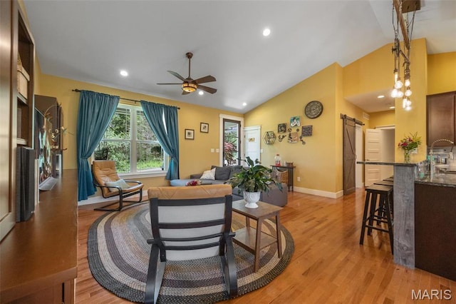 409 Pawnee Dr, Irondale, MO 63648 - living area featuring a barn door, lofted ceiling, light wood-style flooring, a ceiling fan, and baseboards