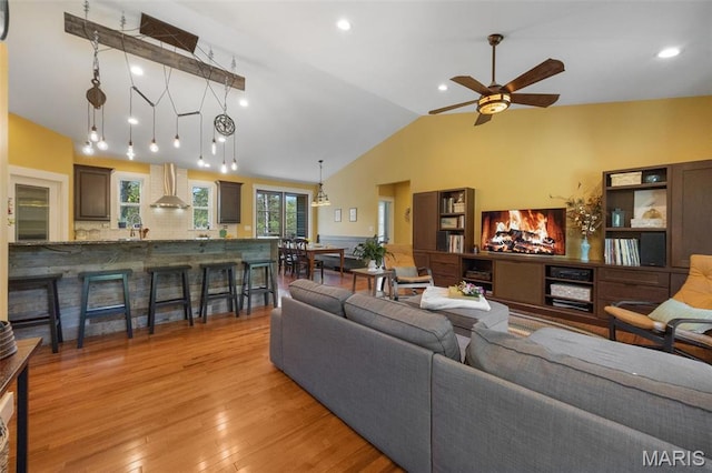 409 Pawnee Dr, Irondale, MO 63648 - living room featuring vaulted ceiling, ceiling fan, light wood finished floors, recessed lighting, and a wainscoted wall