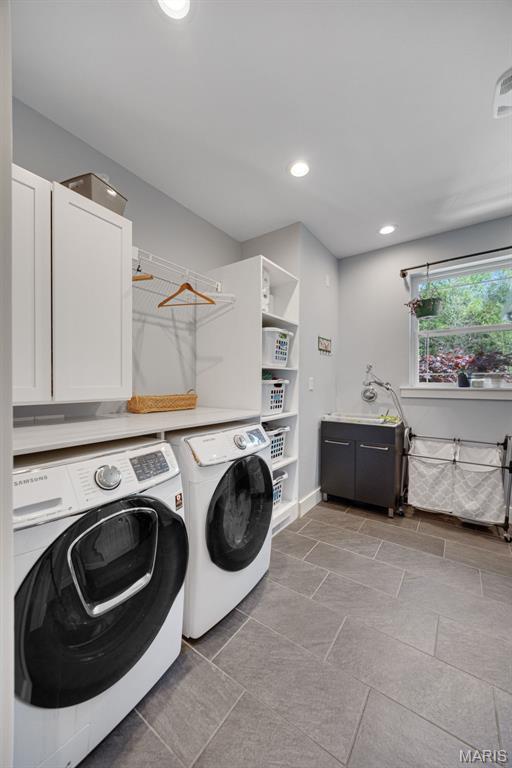 409 Pawnee Dr, Irondale, MO 63648 - clothes washing area featuring washer and dryer, cabinet space, and recessed lighting