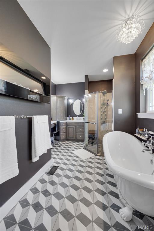 409 Pawnee Dr, Irondale, MO 63648 - full bathroom featuring a shower stall, a freestanding bath, and vanity