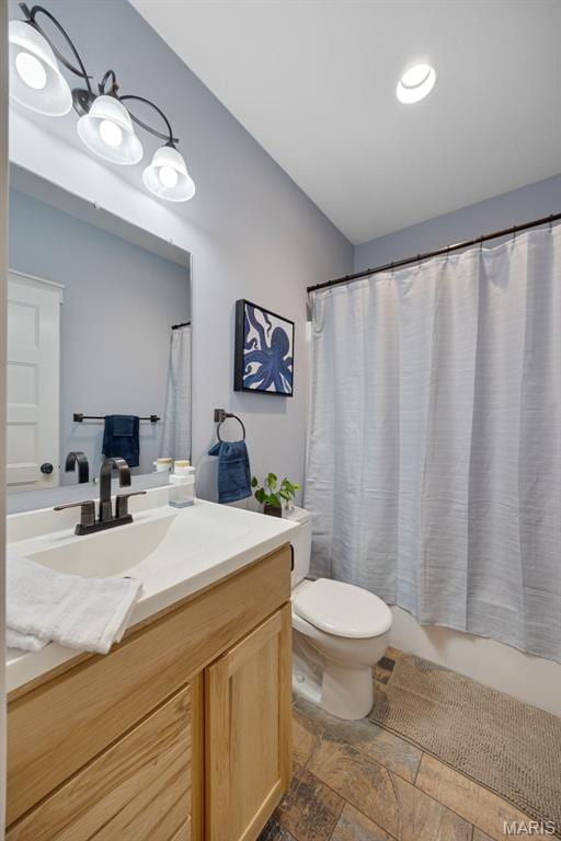 409 Pawnee Dr, Irondale, MO 63648 - full bathroom featuring toilet, vanity, stone finish floors, and shower / tub combo with curtain