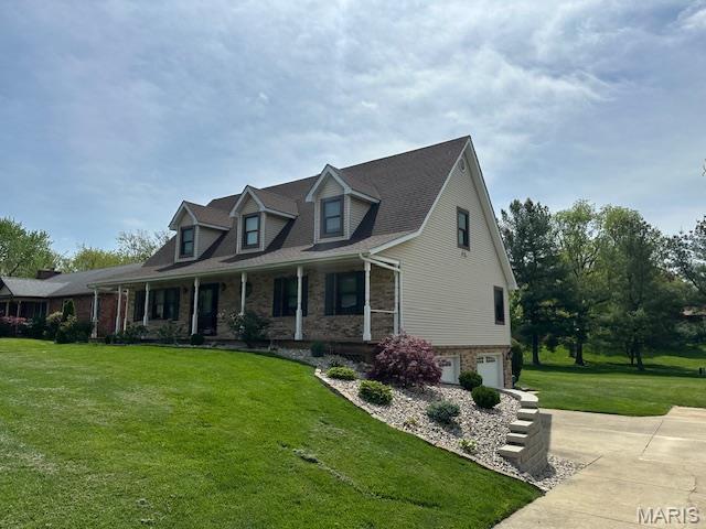 14 Sierra Dr, Glen Carbon, IL 62034 - new england style home with an attached garage, a porch, a front lawn, driveway, and stone siding