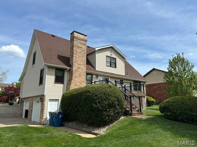14 Sierra Dr, Glen Carbon, IL 62034 - back of property with a chimney, stairs, a yard, a garage, and a deck