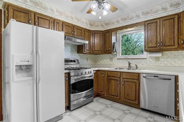 14 Sierra Dr, Glen Carbon, IL 62034 - kitchen featuring appliances with stainless steel finishes, under cabinet range hood, a sink, light floors, and a ceiling fan