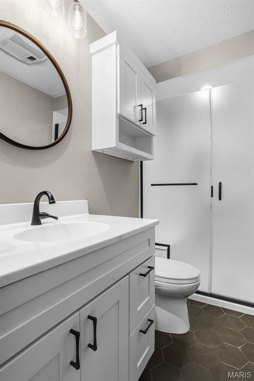 14 Sierra Dr, Glen Carbon, IL 62034 - bathroom featuring vanity, toilet, a textured ceiling, and tile patterned flooring