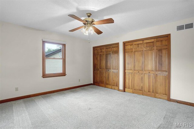 14 Sierra Dr, Glen Carbon, IL 62034 - unfurnished bedroom featuring two closets, carpet flooring, and baseboards