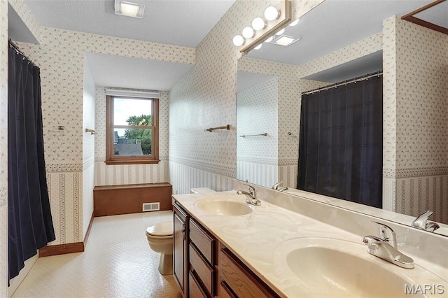 14 Sierra Dr, Glen Carbon, IL 62034 - bathroom featuring wallpapered walls, toilet, double vanity, and a shower with shower curtain