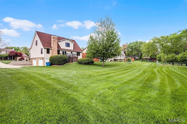 14 Sierra Dr, Glen Carbon, IL 62034 - view of green lawn with an attached garage and concrete driveway
