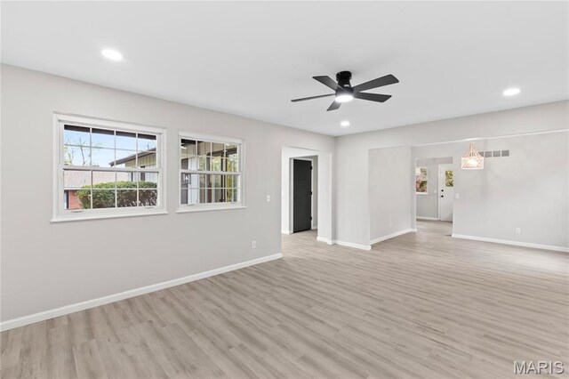 11735 Old Halls Ferry Rd, Florissant, MO 63033 - unfurnished living room with light wood-type flooring, plenty of natural light, baseboards, and recessed lighting