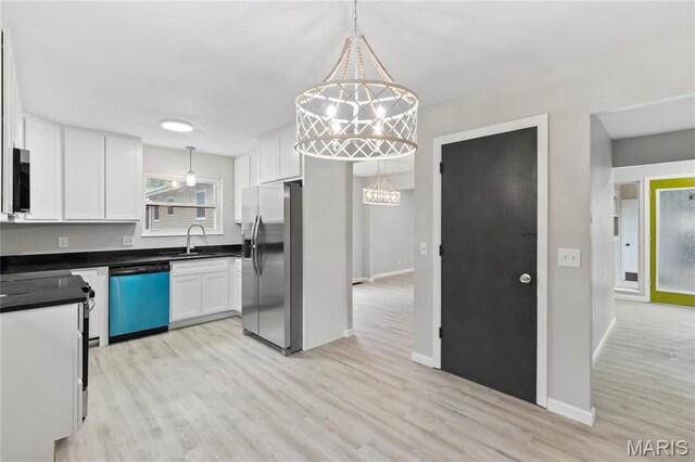 11735 Old Halls Ferry Rd, Florissant, MO 63033 - kitchen featuring appliances with stainless steel finishes, a sink, white cabinets, and light wood-style floors