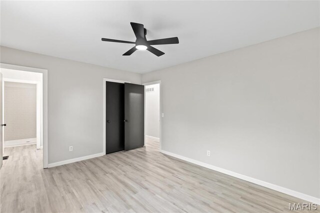 11735 Old Halls Ferry Rd, Florissant, MO 63033 - unfurnished bedroom with light wood-style floors, baseboards, and ceiling fan