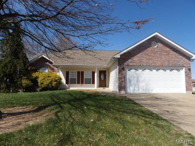 601 John David Dr, Farmington, MO 63640 - single story home with a garage, concrete driveway, a front yard, and brick siding