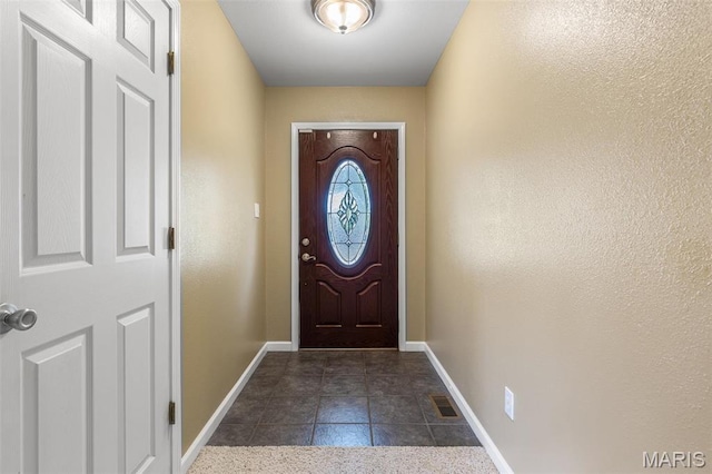 601 John David Dr, Farmington, MO 63640 - doorway to outside featuring baseboards and dark tile patterned flooring
