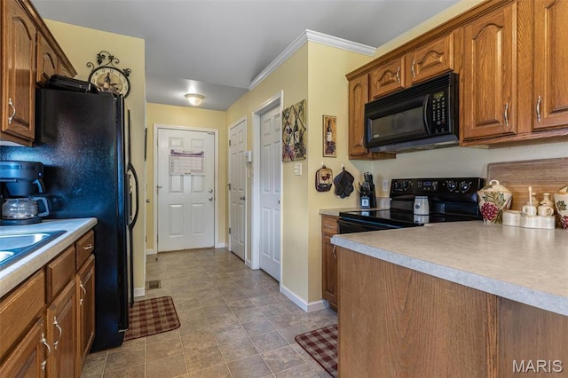 601 John David Dr, Farmington, MO 63640 - kitchen with black appliances, baseboards, brown cabinets, light countertops, and crown molding