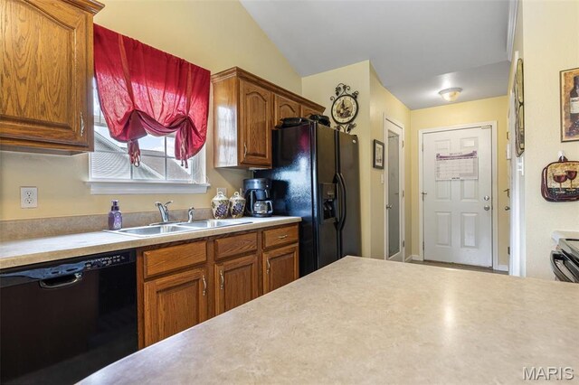 601 John David Dr, Farmington, MO 63640 - kitchen featuring black appliances, a sink, light countertops, and vaulted ceiling