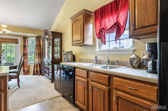 601 John David Dr, Farmington, MO 63640 - kitchen featuring black dishwasher, a sink, lofted ceiling, light countertops, and light colored carpet