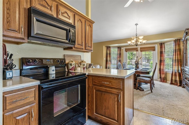 601 John David Dr, Farmington, MO 63640 - kitchen with black appliances, a chandelier, brown cabinets, light countertops, and a peninsula