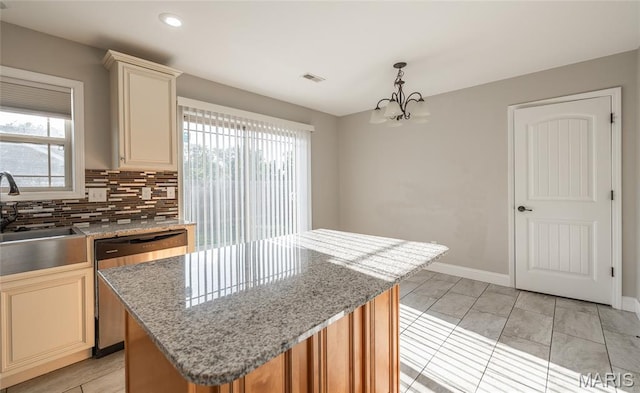 11175 Lexington Ln, Rolla, MO 65401 - kitchen with cream cabinets, a sink, stainless steel dishwasher, a center island, and recessed lighting