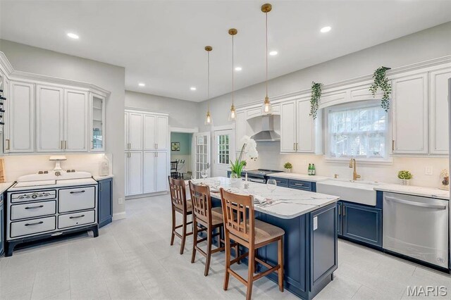 100 Lewis St, Troy, MO 63379 - kitchen with stainless steel dishwasher, a sink, extractor fan, blue cabinets, and a breakfast bar area
