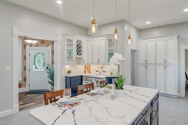 100 Lewis St, Troy, MO 63379 - kitchen with white cabinetry, decorative light fixtures, glass insert cabinets, light stone countertops, and recessed lighting