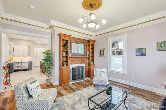 100 Lewis St, Troy, MO 63379 - sitting room with a chandelier, ornamental molding, wood finished floors, a high end fireplace, and baseboards