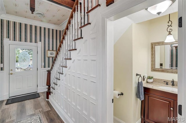 100 Lewis St, Troy, MO 63379 - foyer entrance with stairs, dark wood-style floors, baseboards, ornamental molding, and wallpapered walls