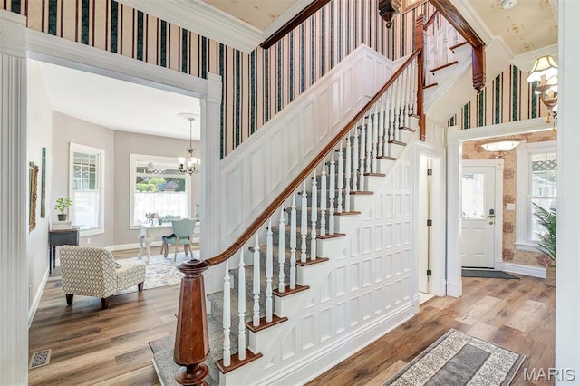 100 Lewis St, Troy, MO 63379 - stairs featuring wallpapered walls, ornamental molding, a chandelier, baseboards, and wood finished floors