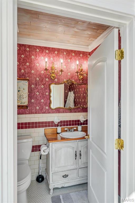 100 Lewis St, Troy, MO 63379 - half bath with toilet, a wainscoted wall, vanity, tile walls, and crown molding