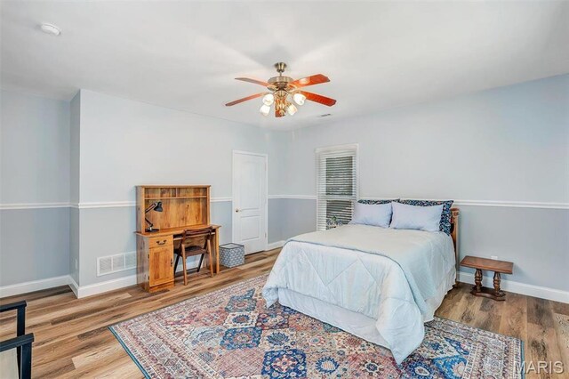 100 Lewis St, Troy, MO 63379 - bedroom featuring baseboards, wood finished floors, and a ceiling fan