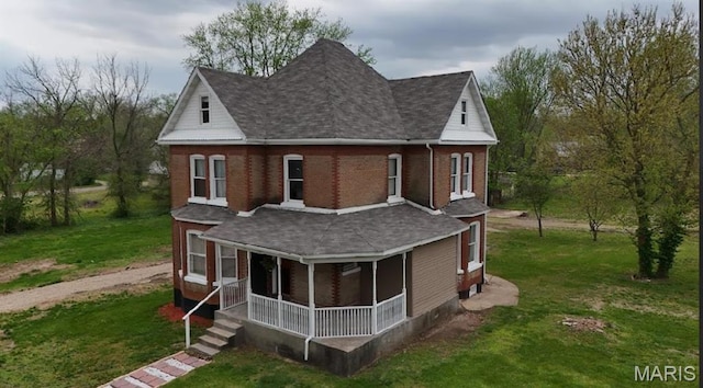 203 S B St, Bonne Terre, MO 63628 - rear view of house featuring a shingled roof and a yard