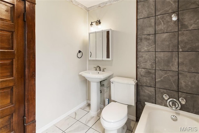 203 S B St, Bonne Terre, MO 63628 - bathroom with a tub, toilet, marble finish floors, and baseboards