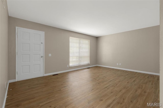 2126 Aristocrat Dr, Florissant, MO 63031 - spare room with wood finished floors and baseboards