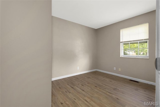 2126 Aristocrat Dr, Florissant, MO 63031 - spare room featuring wood finished floors and baseboards