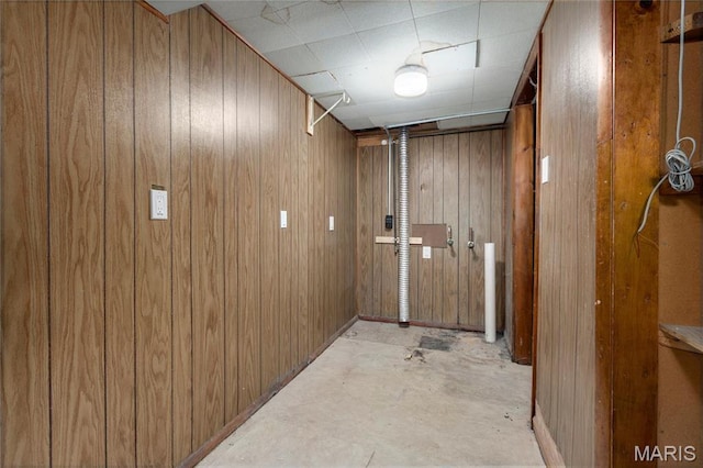 2126 Aristocrat Dr, Florissant, MO 63031 - hallway featuring wood walls and unfinished concrete floors