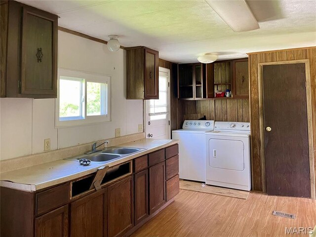 12678 Hyfield Rd, De Soto, MO 63020 - washroom with independent washer and dryer, cabinet space, light wood-style flooring, and wood walls