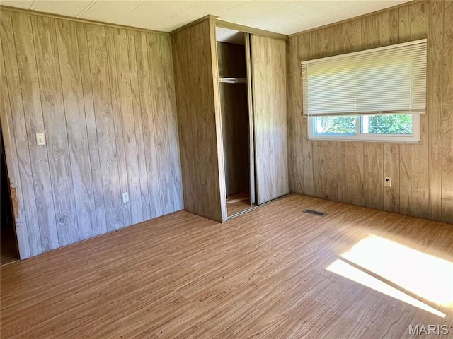 12678 Hyfield Rd, De Soto, MO 63020 - unfurnished bedroom featuring wood finished floors, a closet, and wooden walls