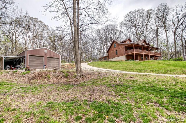 234 SE 350th St, Carrollton, IL 62016 - view of grassy yard with an outdoor structure, a detached garage, and a deck