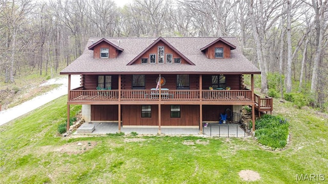 234 SE 350th St, Carrollton, IL 62016 - back of property featuring log siding, a yard, a deck, a view of trees, and a shingled roof