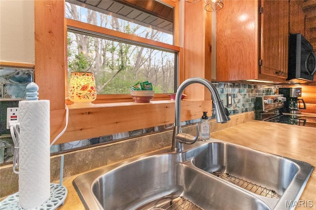 234 SE 350th St, Carrollton, IL 62016 - kitchen view of a sink, black microwave, decorative backsplash, brown cabinets, and light countertops