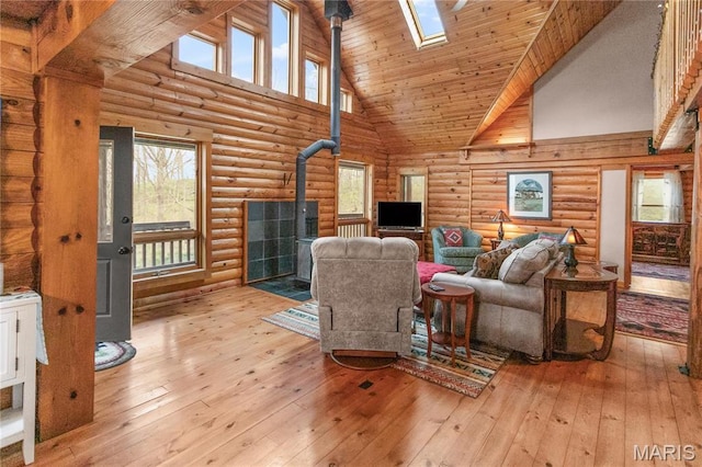 234 SE 350th St, Carrollton, IL 62016 - living area with a wood stove, log walls, high vaulted ceiling, healthy amount of natural light, and light wood-style floors