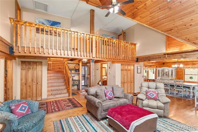234 SE 350th St, Carrollton, IL 62016 - living area featuring high vaulted ceiling, wood finished floors, a ceiling fan, stairway, and a chandelier