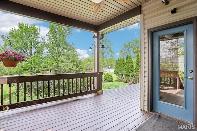 wooden terrace with a ceiling fan