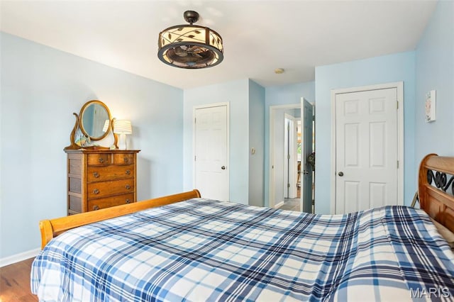bedroom featuring baseboards and wood finished floors