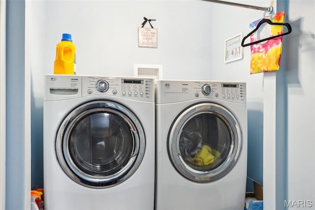 laundry room with washing machine and clothes dryer
