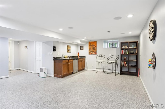 indoor wet bar featuring dishwasher, recessed lighting, and baseboards