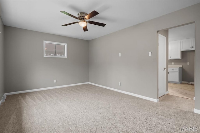 1399 Valli Ln, Saint Charles, MO 63304 - spare room featuring ceiling fan, light carpet, and baseboards