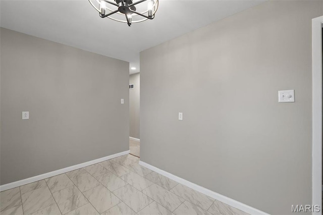 1399 Valli Ln, Saint Charles, MO 63304 - empty room featuring a chandelier, light marble finish floors, and baseboards