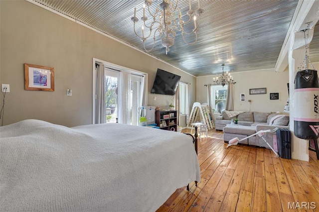 305 N Main St, Saint Genevieve, MO 63670 - bedroom with a chandelier, access to outside, ornamental molding, and light wood-style flooring